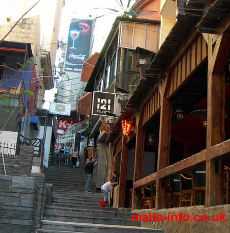 Photograph of steps in Paceville, full of bars restaurants and cafes